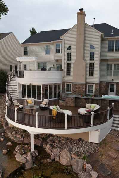 Example of a large trendy backyard outdoor kitchen deck design with a pergola