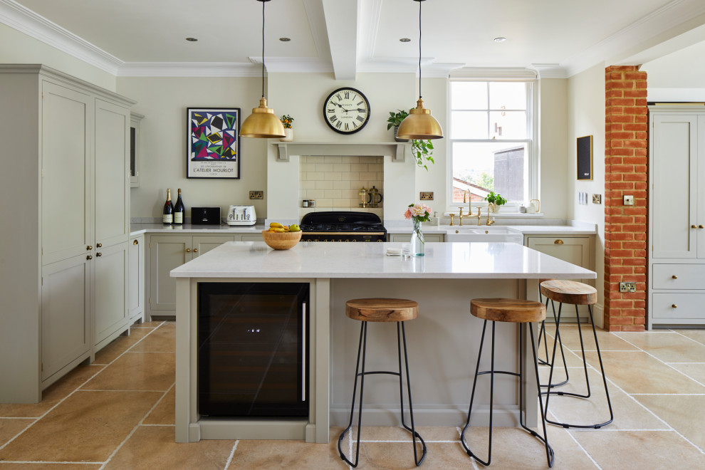 This is an example of a mid-sized traditional l-shaped open plan kitchen in London with a farmhouse sink, shaker cabinets, grey cabinets, marble benchtops, beige splashback, porcelain splashback, panelled appliances, limestone floors, with island, beige floor, white benchtop and coffered.