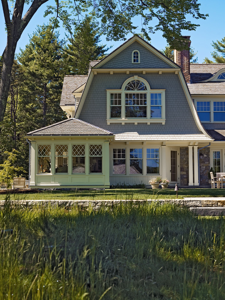 Inspiration for a traditional two-storey grey exterior in Boston with wood siding and a gambrel roof.