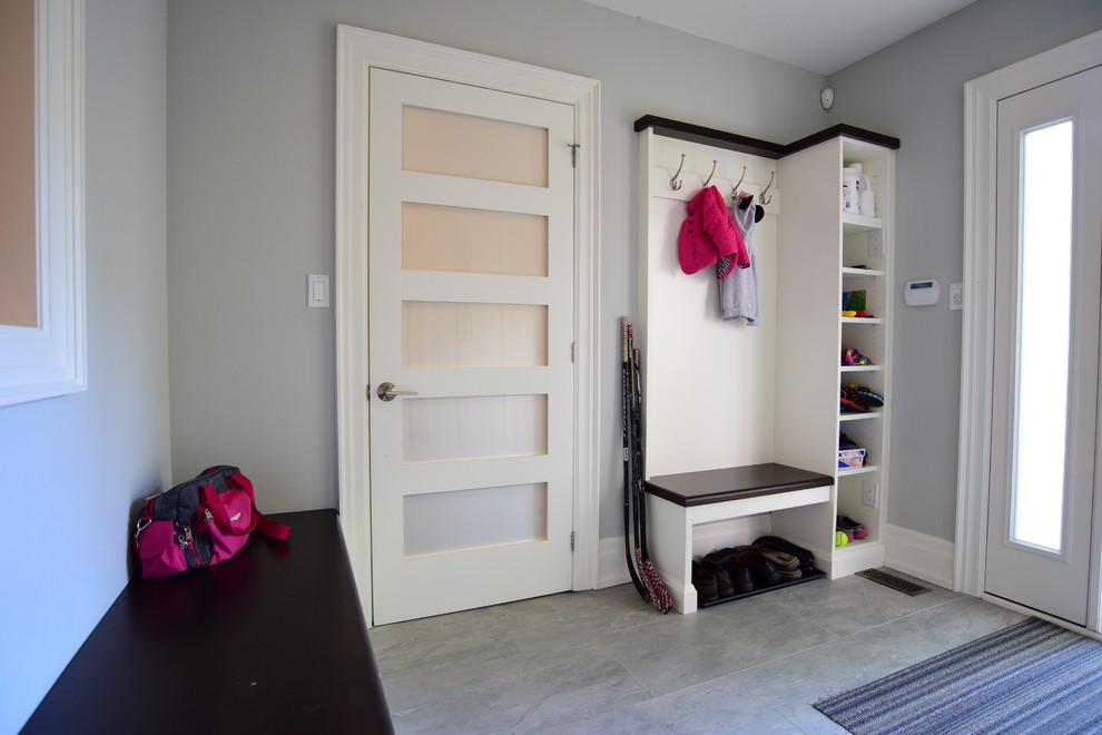 Example of a porcelain tile and gray floor entryway design in Toronto
