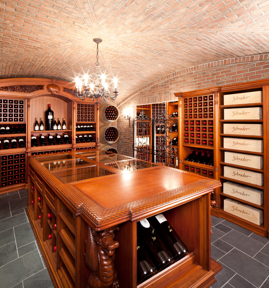 This is an example of an expansive traditional wine cellar in New York with display racks and grey floor.