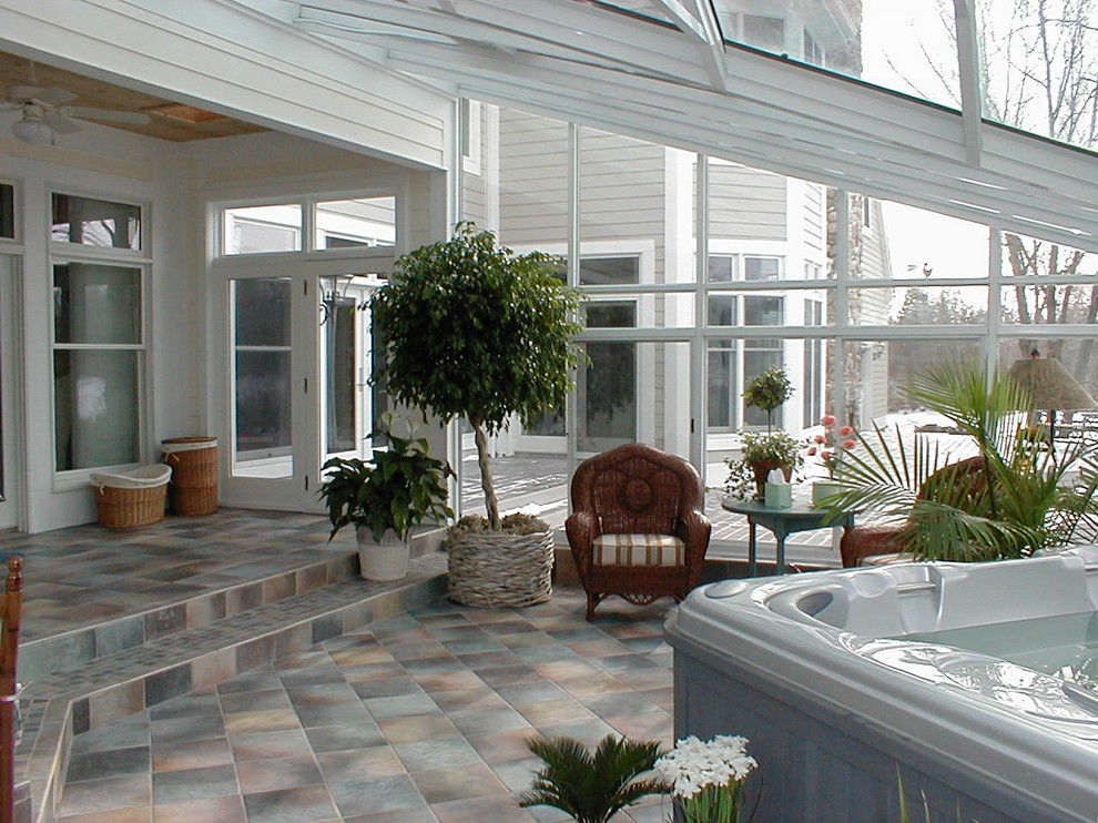 Photo of a large transitional sunroom in Detroit with ceramic floors, no fireplace, a skylight and grey floor.