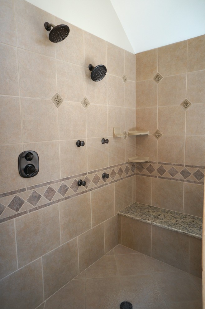 This is an example of a large traditional bathroom in Chicago with an undermount sink, granite benchtops, a double shower, a one-piece toilet, beige tile, ceramic tile, beige walls and ceramic floors.