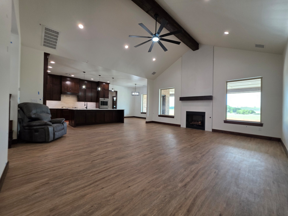 The large windows on each side of the fireplace offer stunning views of the coun