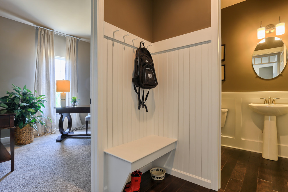This is an example of a small traditional mudroom in Philadelphia with brown walls.