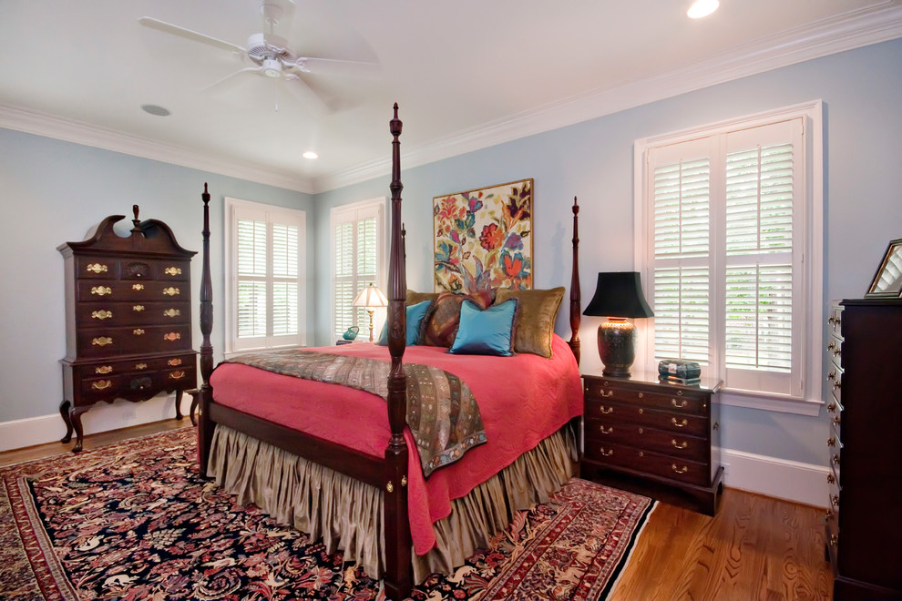 Inspiration for a mid-sized traditional master bedroom in Other with blue walls and medium hardwood floors.