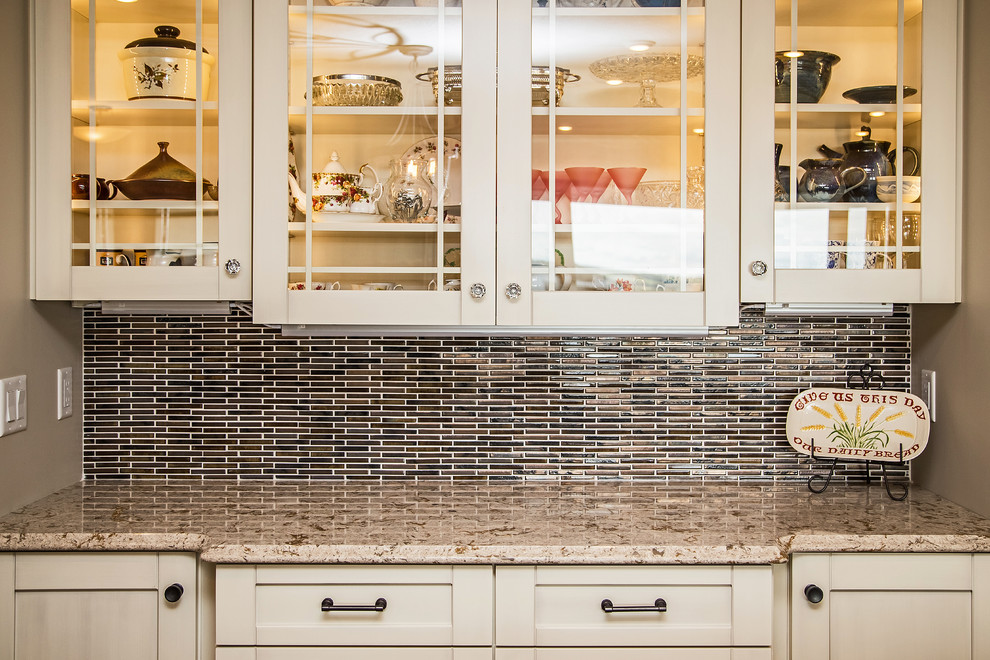 Kitchen - transitional medium tone wood floor kitchen idea in Calgary with an undermount sink, shaker cabinets, white cabinets, quartz countertops, white backsplash, porcelain backsplash and stainless steel appliances