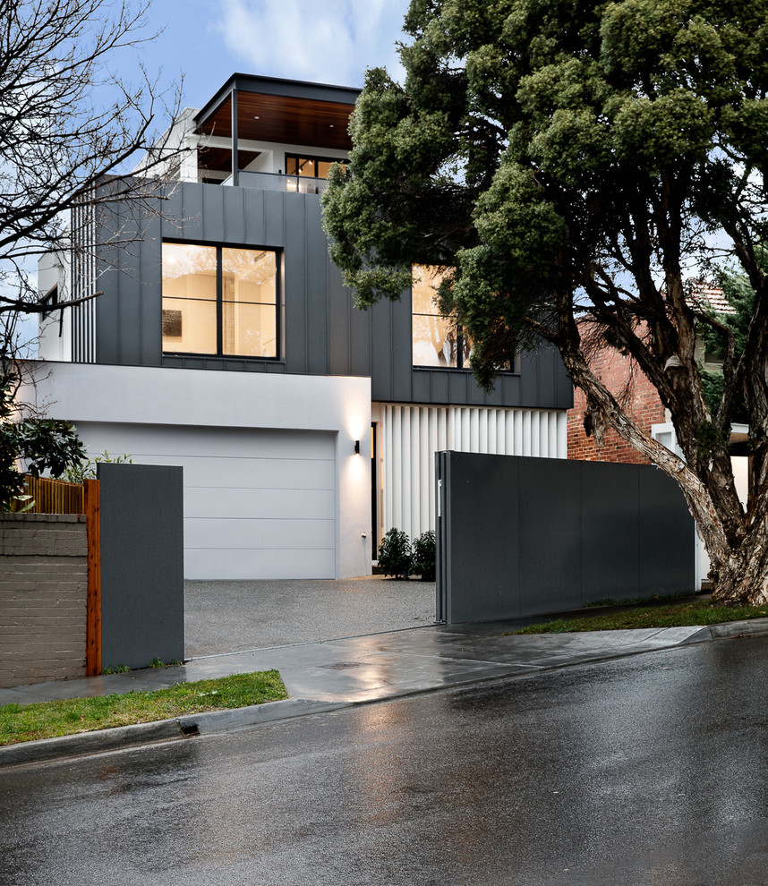 Inspiration for a large contemporary three-storey grey house exterior in Melbourne with metal siding and a metal roof.