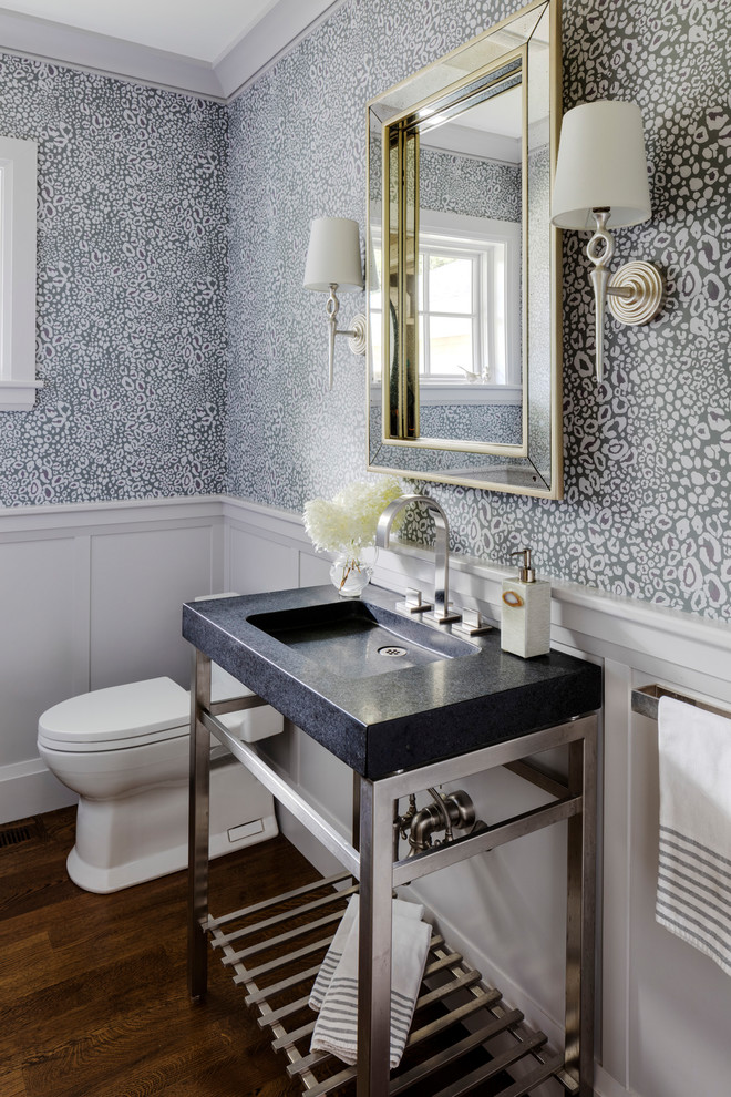 Mid-sized contemporary powder room in Boston with open cabinets, a one-piece toilet, multi-coloured walls, medium hardwood floors, a console sink, soapstone benchtops and brown floor.