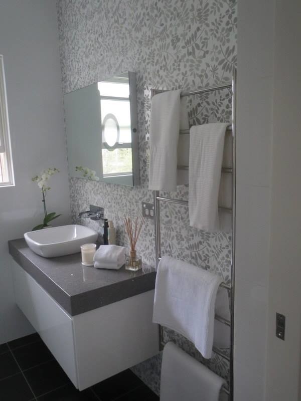 Design ideas for a small contemporary 3/4 bathroom in Sydney with flat-panel cabinets, white cabinets, gray tile, a vessel sink, engineered quartz benchtops and black floor.