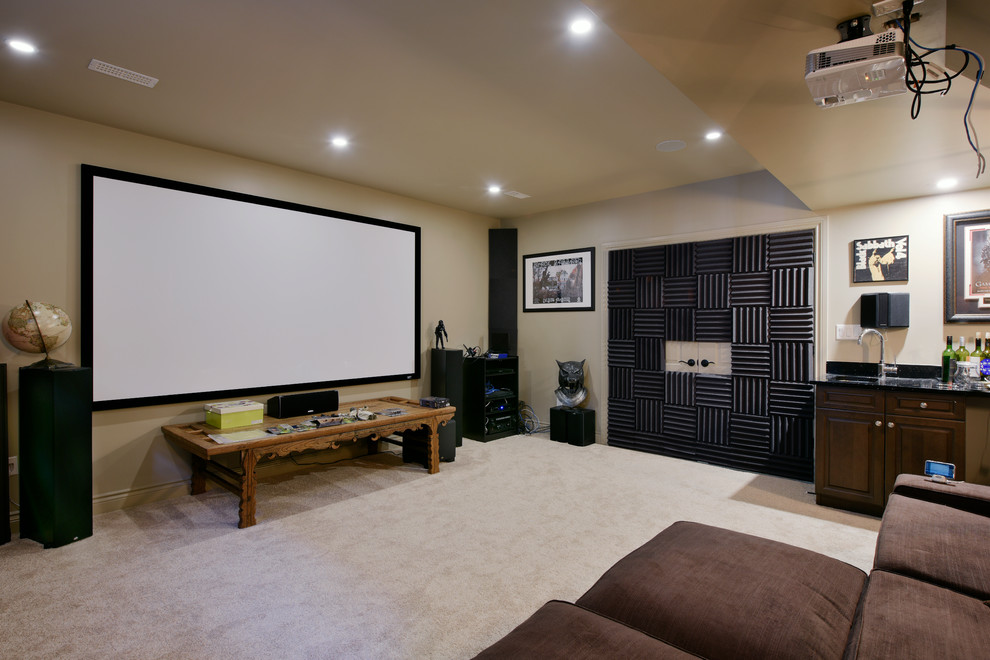 This is an example of a large midcentury enclosed home theatre in Ottawa with beige walls, carpet and a projector screen.