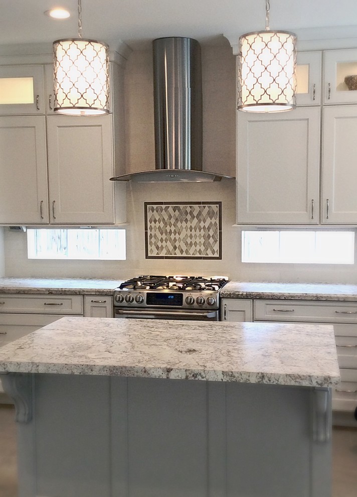 Eat-in kitchen - mid-sized transitional u-shaped ceramic tile eat-in kitchen idea in Houston with a farmhouse sink, recessed-panel cabinets, white cabinets, granite countertops, white backsplash, stone tile backsplash, stainless steel appliances and an island