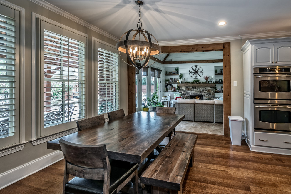 Inspiration for a mid-sized traditional kitchen/dining combo in Other with medium hardwood floors and brown floor.