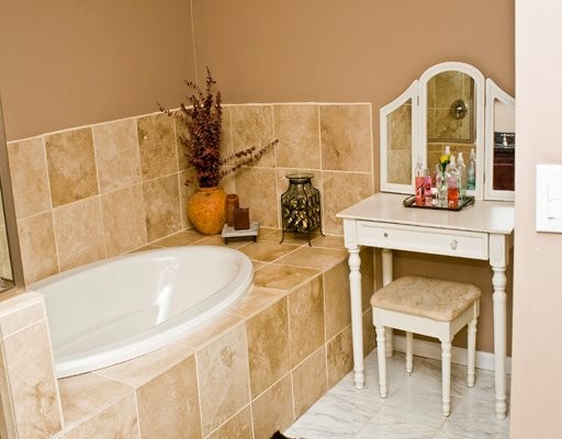 Inspiration for a mid-sized transitional beige tile and ceramic tile marble floor and gray floor drop-in bathtub remodel in Chicago with brown walls