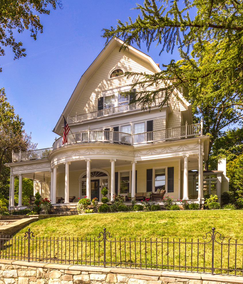 Elegant beige three-story house exterior photo in DC Metro with a gambrel roof