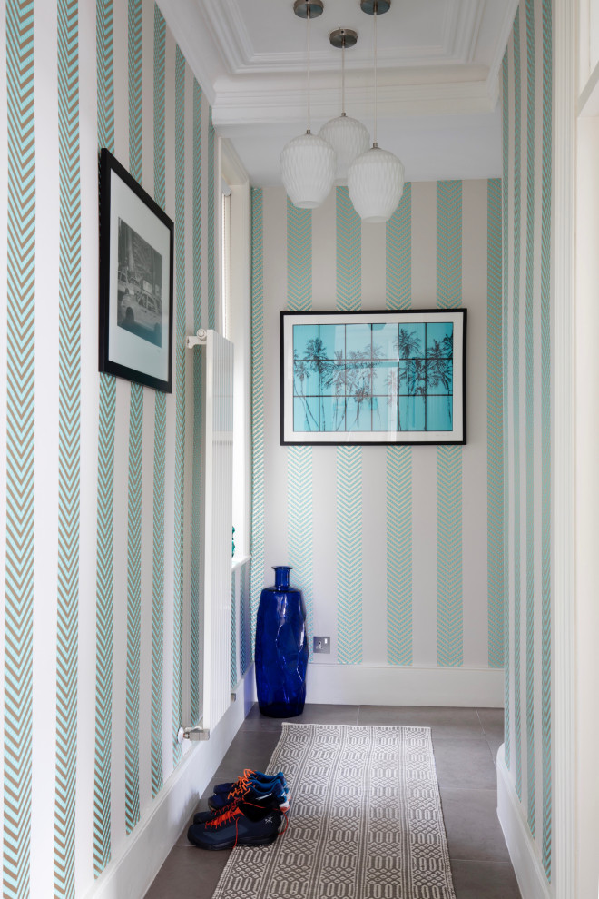 This is an example of a mid-sized contemporary hallway in London with multi-coloured walls, porcelain floors, grey floor and wallpaper.