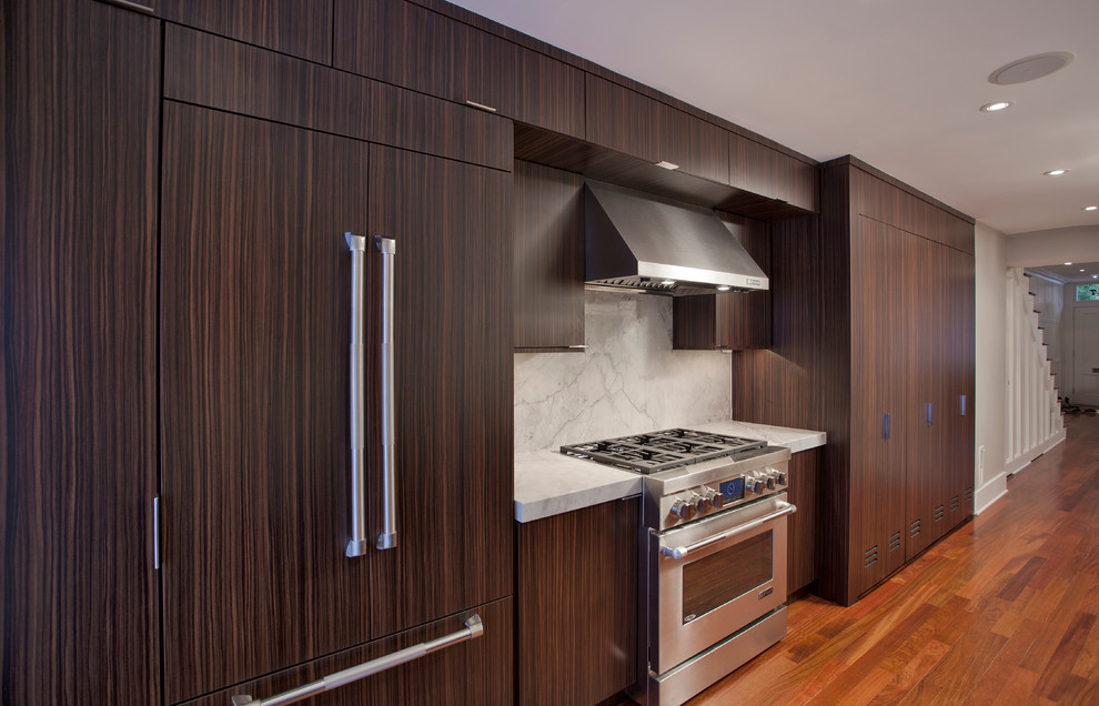 Enclosed kitchen - mid-sized transitional galley medium tone wood floor and brown floor enclosed kitchen idea in DC Metro with an undermount sink, flat-panel cabinets, dark wood cabinets, marble countertops, gray backsplash, stone slab backsplash, stainless steel appliances and no island