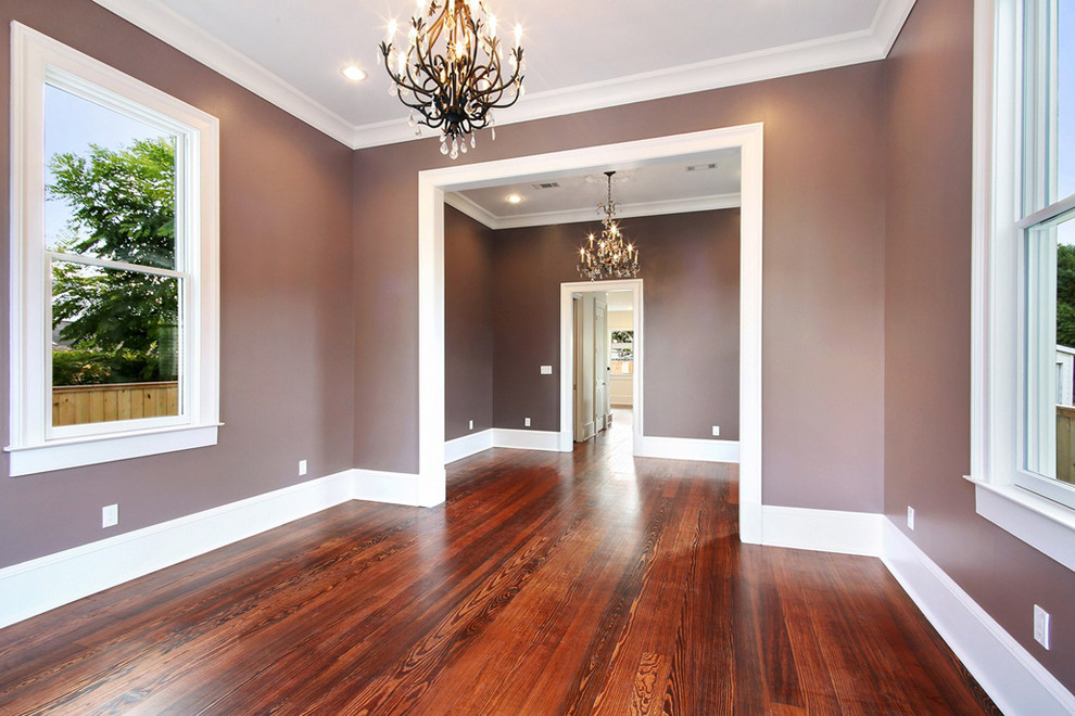 Photo of a small traditional open plan dining in New Orleans with purple walls, medium hardwood floors and brown floor.