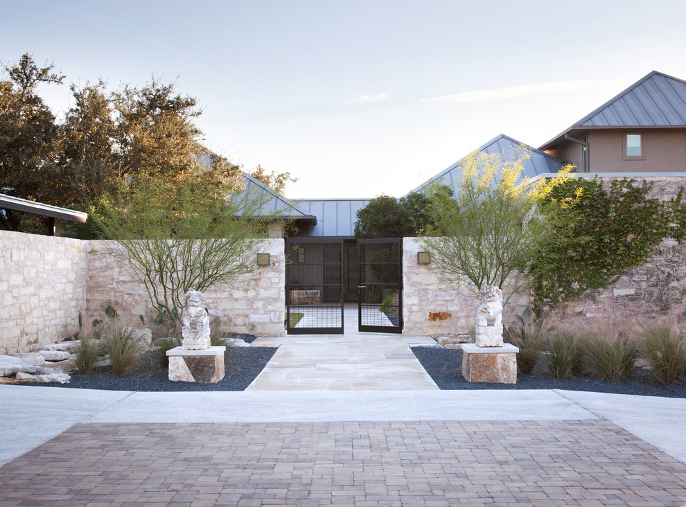 Inspiration for a contemporary front yard garden in Austin with natural stone pavers.