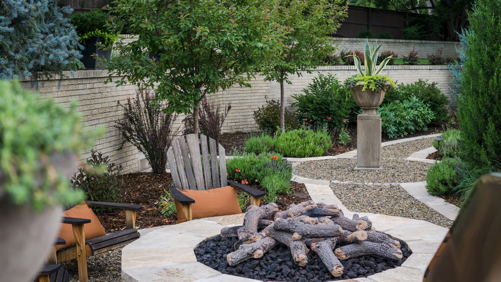 Design ideas for a traditional backyard formal garden in Denver with a fire feature and gravel.