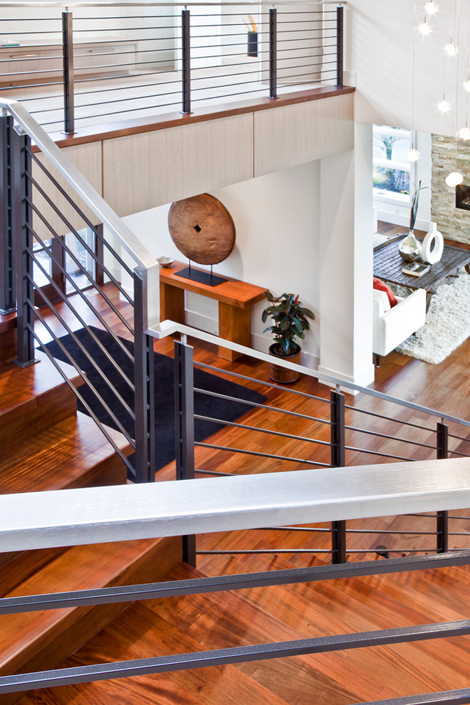 Inspiration for a large contemporary wood straight staircase in Seattle with wood risers and metal railing.