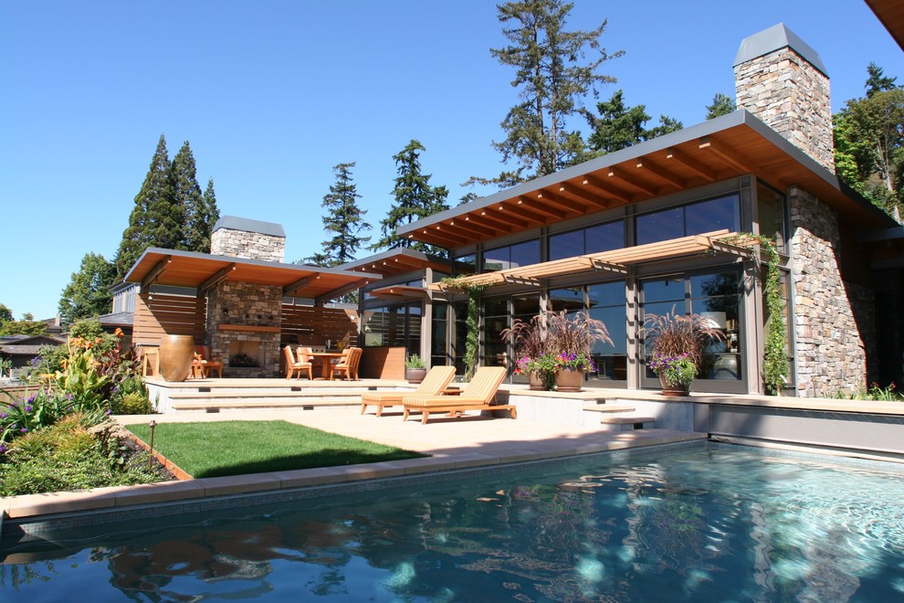 Inspiration for a large contemporary backyard rectangular lap pool in Seattle with a hot tub and concrete pavers.