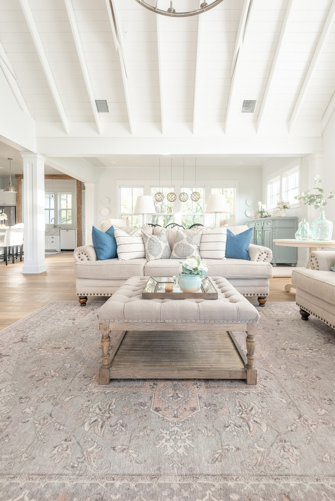 Example of a large farmhouse light wood floor, vaulted ceiling and shiplap wall family room design in Dallas with white walls, a standard fireplace, a tile fireplace and a wall-mounted tv