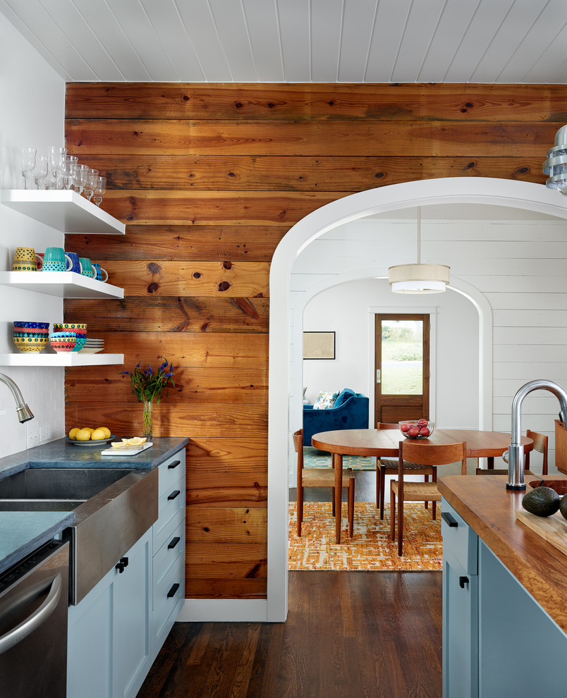 Design ideas for an eat-in kitchen in Austin with a farmhouse sink, shaker cabinets, blue cabinets, wood benchtops, white splashback, subway tile splashback, dark hardwood floors and with island.