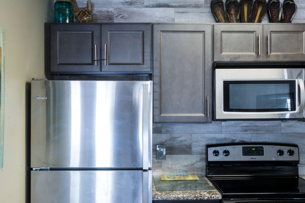 Eat-in kitchen - small rustic u-shaped cement tile floor and beige floor eat-in kitchen idea with an undermount sink, flat-panel cabinets, medium tone wood cabinets, granite countertops, gray backsplash, ceramic backsplash, stainless steel appliances, a peninsula and gray countertops