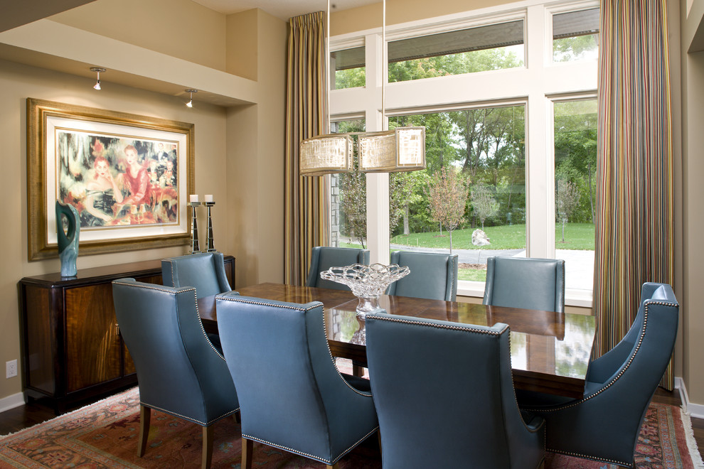 Photo of a contemporary dining room in Minneapolis with beige walls and dark hardwood floors.