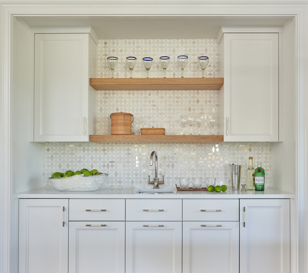 Inspiration for a beach style l-shaped eat-in kitchen in Boston with an undermount sink, recessed-panel cabinets, white cabinets, quartzite benchtops, white splashback, ceramic splashback, stainless steel appliances, light hardwood floors, with island, brown floor, white benchtop and timber.