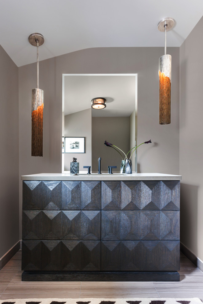 This is an example of a mid-sized contemporary 3/4 bathroom in Los Angeles with furniture-like cabinets, dark wood cabinets, an alcove shower, beige tile, brown tile, porcelain tile, brown walls, porcelain floors, an undermount sink, brown floor, a hinged shower door and beige benchtops.