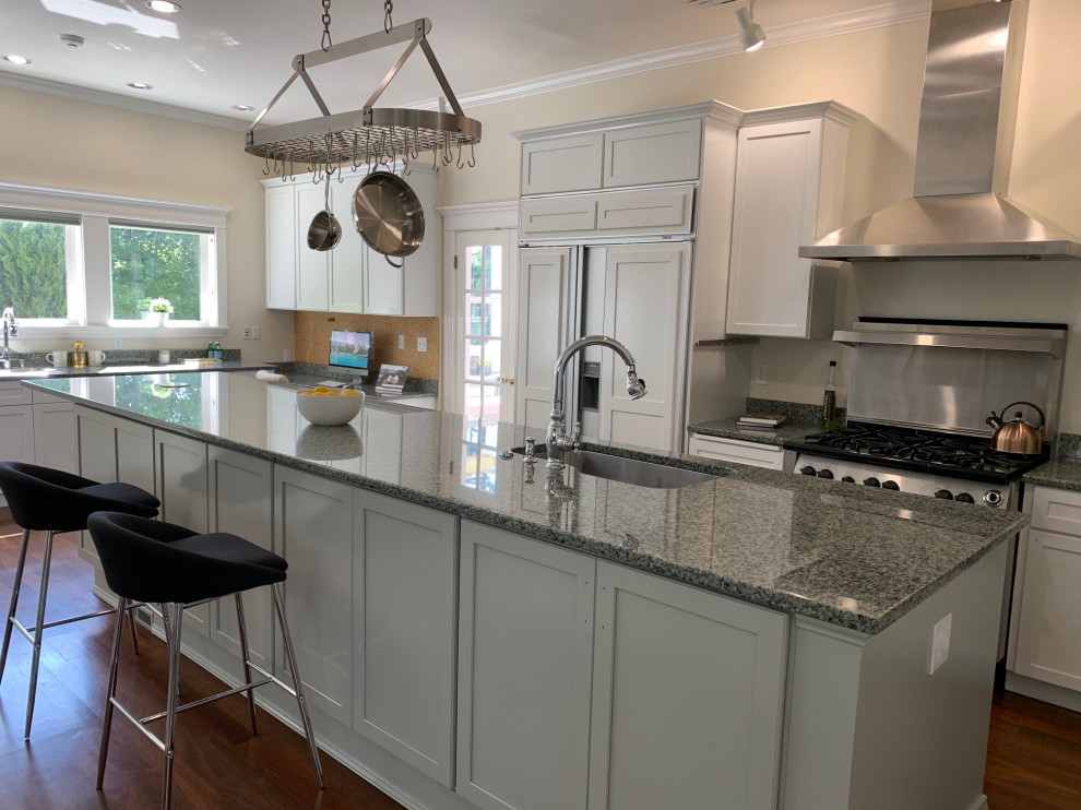Enclosed kitchen - large transitional single-wall dark wood floor and brown floor enclosed kitchen idea in Seattle with an undermount sink, shaker cabinets, white cabinets, granite countertops, gray backsplash, metal backsplash, stainless steel appliances, an island and gray countertops