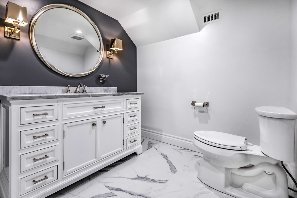Photo of a mid-sized powder room in Los Angeles with shaker cabinets, white cabinets, a one-piece toilet, grey walls, porcelain floors, an undermount sink, marble benchtops and multi-coloured floor.