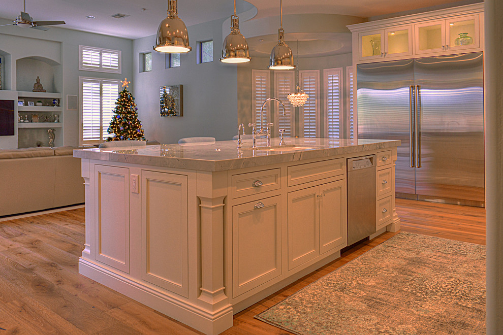 Example of a large transitional l-shaped medium tone wood floor kitchen design in Phoenix with an undermount sink, recessed-panel cabinets, white cabinets, gray backsplash, subway tile backsplash, stainless steel appliances and an island
