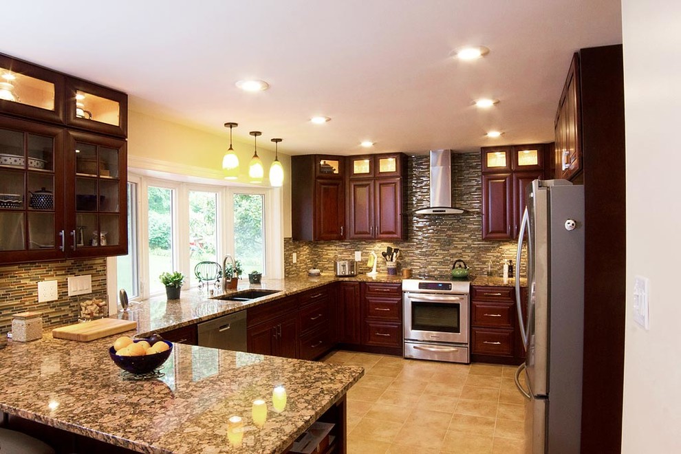 Inspiration for a large transitional u-shaped ceramic tile open concept kitchen remodel in DC Metro with a double-bowl sink, dark wood cabinets, granite countertops, gray backsplash, mosaic tile backsplash and stainless steel appliances