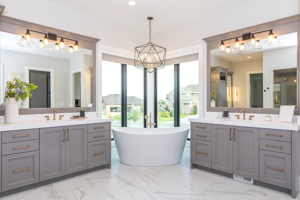 Inspiration for a large transitional master bathroom in Salt Lake City with recessed-panel cabinets, grey cabinets, ceramic floors, an undermount sink, quartzite benchtops, white benchtops, a freestanding tub, white walls and white floor.