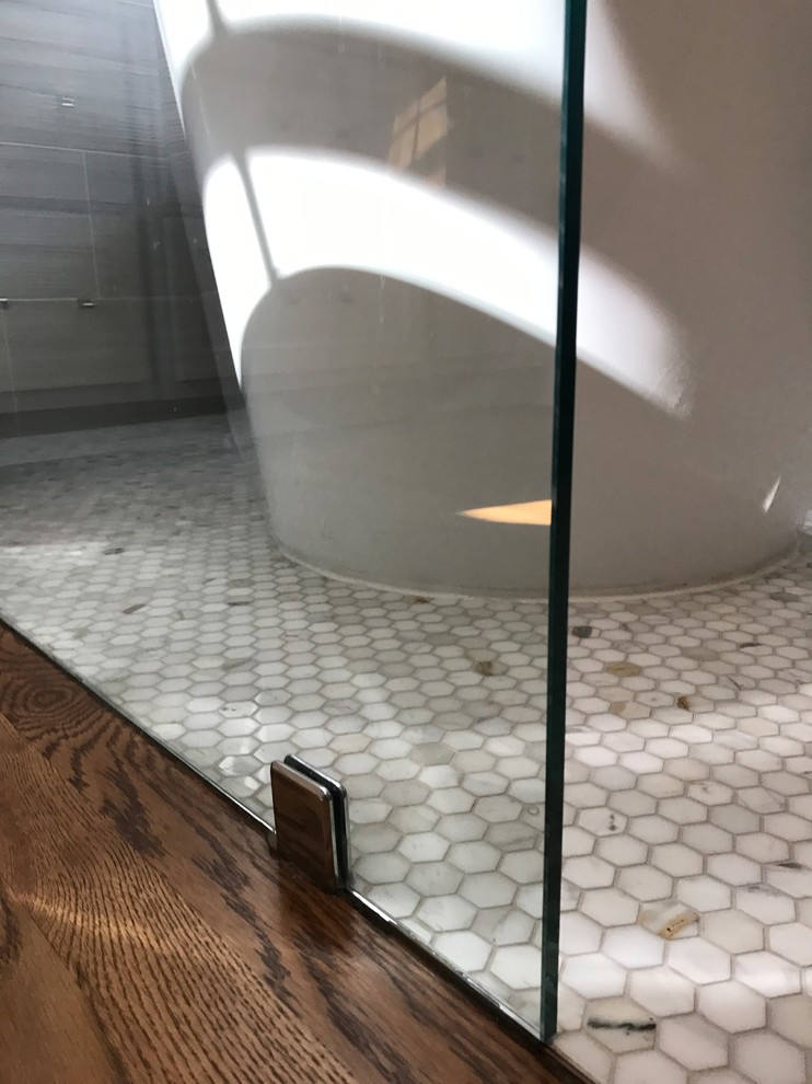 Inspiration for a mid-sized contemporary master wet room bathroom in Other with shaker cabinets, white cabinets, a freestanding tub, gray tile, mosaic tile, white walls, marble floors, an undermount sink, marble benchtops, a one-piece toilet and white floor.