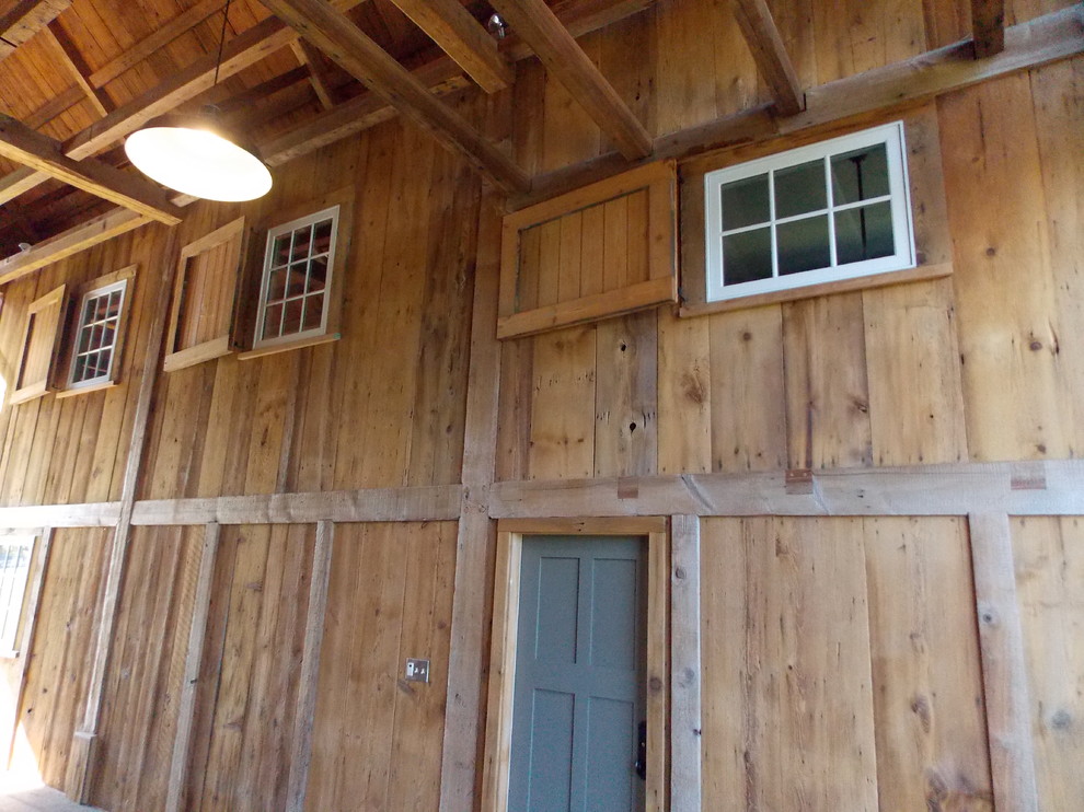 Inspiration for a mid-sized rustic three-story brick brown and medium tone wood floor front door remodel in Burlington with brown walls and a blue front door