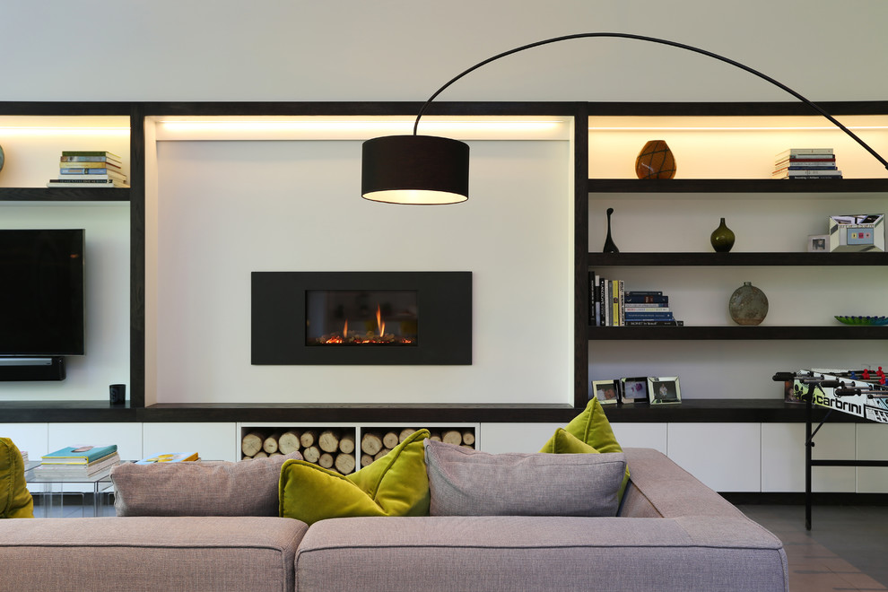 Photo of a large contemporary open concept living room in London with white walls, ceramic floors, a standard fireplace, a metal fireplace surround, grey floor and a wall-mounted tv.
