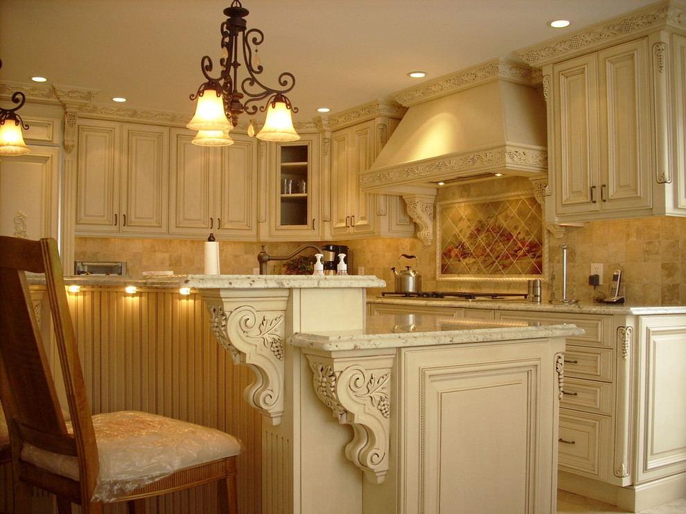 This is an example of a traditional kitchen in Philadelphia with raised-panel cabinets, beige cabinets and beige splashback.