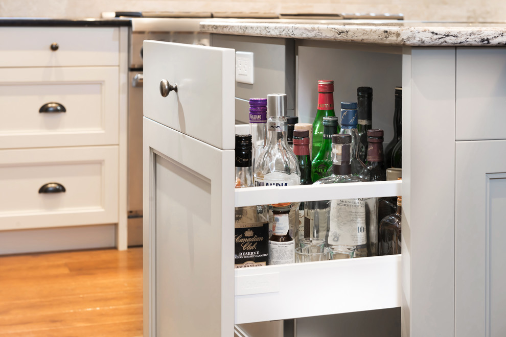 Home design - transitional u-shaped medium tone wood floor home design idea in Ottawa with recessed-panel cabinets, gray cabinets and quartz countertops