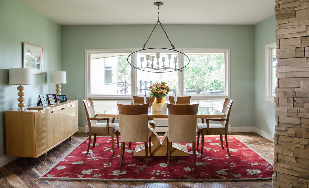 Mid-sized transitional medium tone wood floor kitchen/dining room combo photo in Denver with green walls, a stone fireplace and a two-sided fireplace