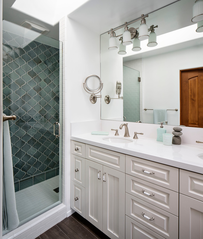 Design ideas for a mid-sized beach style master bathroom in San Francisco with an undermount sink, white cabinets, quartzite benchtops, an alcove shower, blue tile, ceramic tile, white walls, porcelain floors, raised-panel cabinets, a two-piece toilet, a double vanity and a built-in vanity.