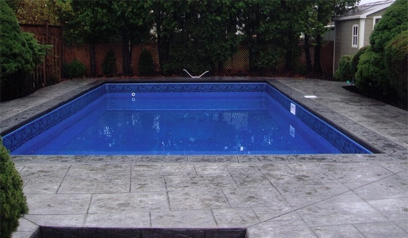 Mid-sized backyard concrete paver and rectangular lap pool photo