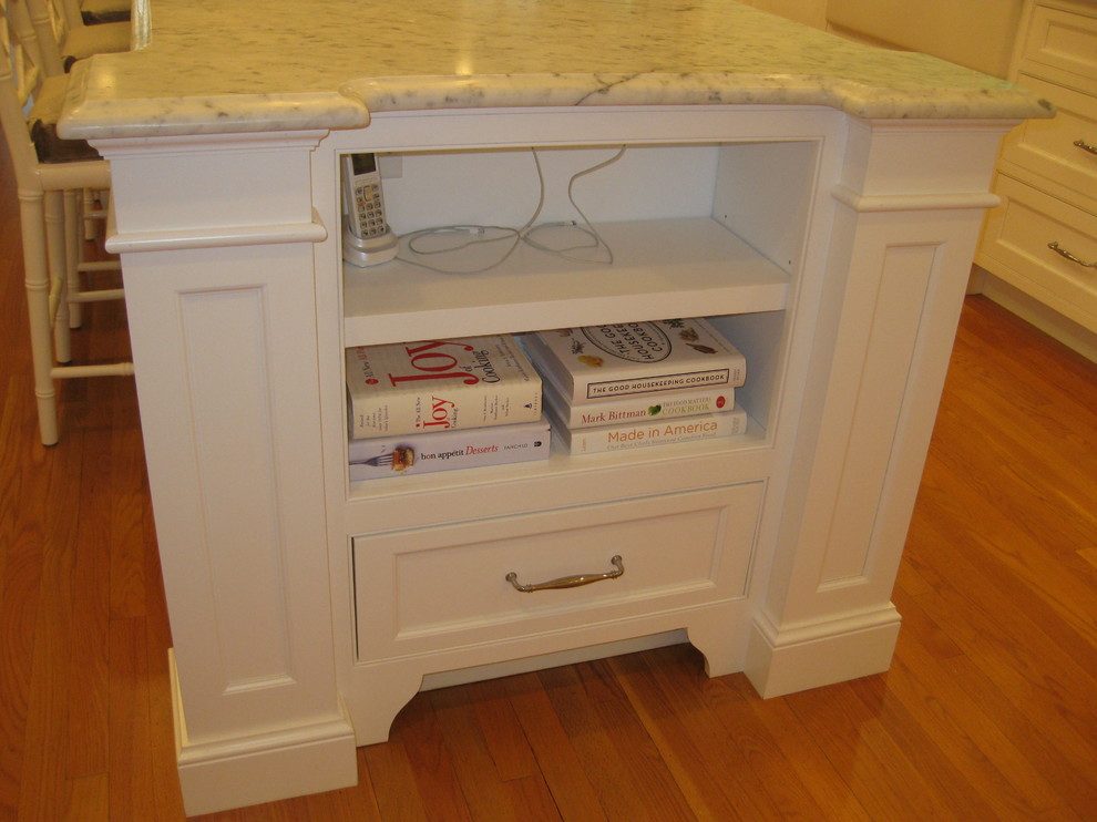 Example of a transitional u-shaped medium tone wood floor eat-in kitchen design in Boston with beaded inset cabinets, white cabinets, marble countertops, white backsplash, an island, a farmhouse sink, subway tile backsplash and stainless steel appliances