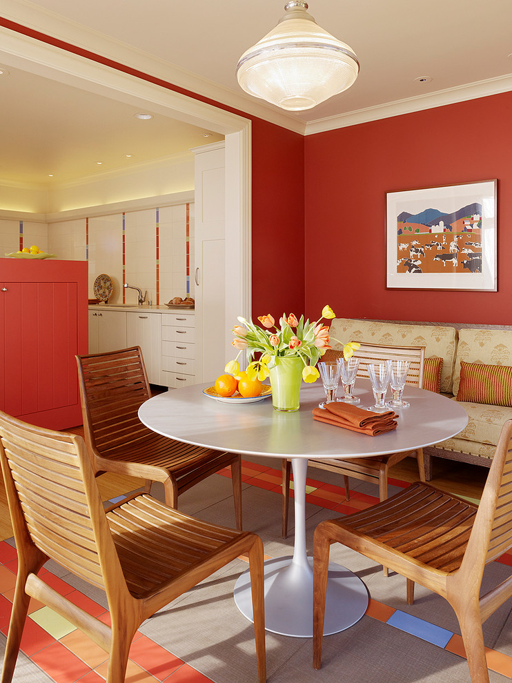 Large eclectic kitchen/dining combo in San Francisco with red walls, ceramic floors and no fireplace.