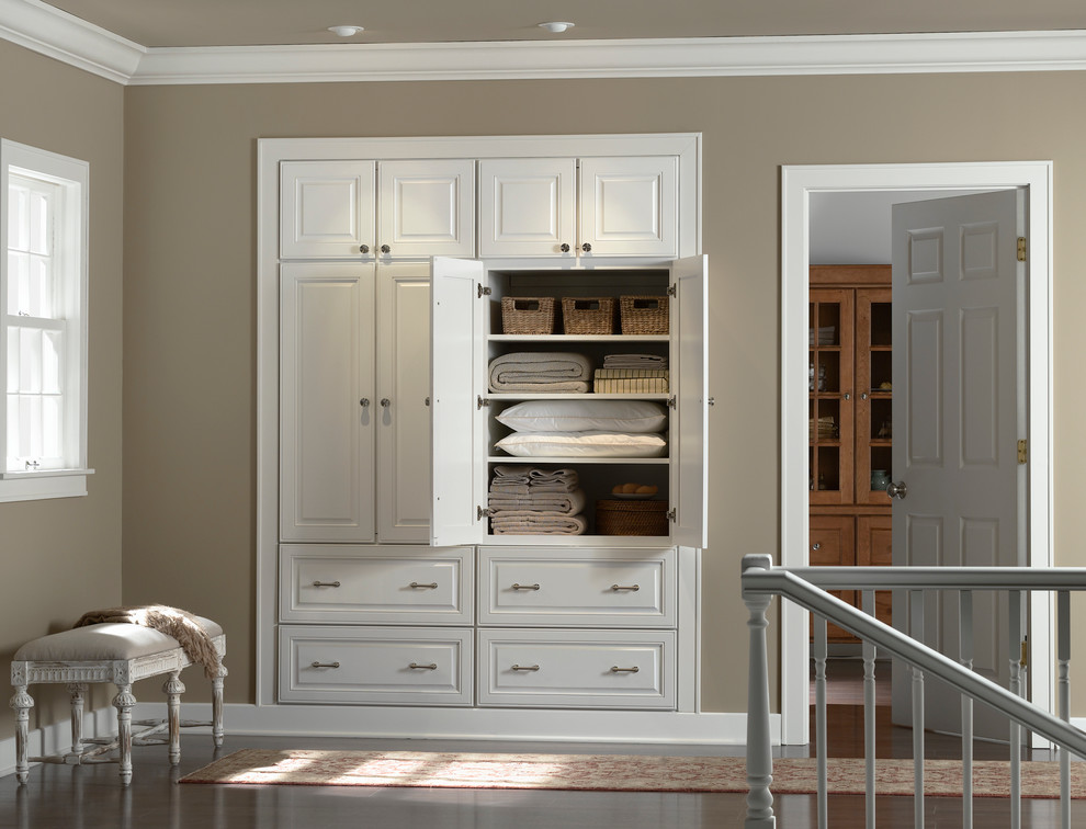 Example of a mid-sized classic dark wood floor and brown floor hallway design in Orange County with brown walls