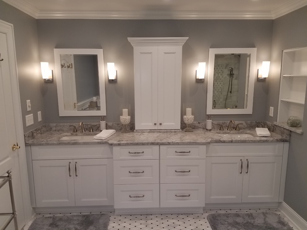 Design ideas for a large transitional master bathroom in New York with recessed-panel cabinets, white cabinets, a freestanding tub, a curbless shower, a wall-mount toilet, black and white tile, marble, grey walls, mosaic tile floors, an undermount sink, quartzite benchtops, grey floor and a hinged shower door.