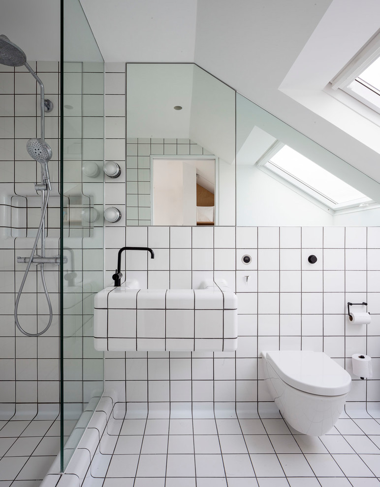 Photo of a mid-sized contemporary master bathroom in London with glass-front cabinets, an open shower, black and white tile, ceramic tile, white walls, light hardwood floors, white floor, a wall-mount toilet, a wall-mount sink and an open shower.